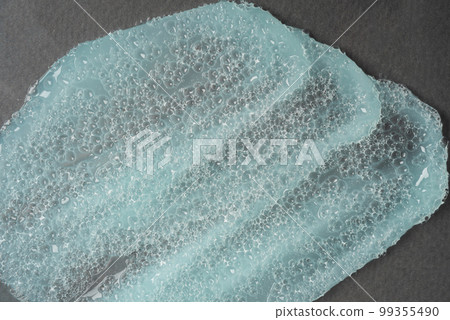 Close-up cosmetic product with bubble texture. Smear of cosmetics for face and body 99355490