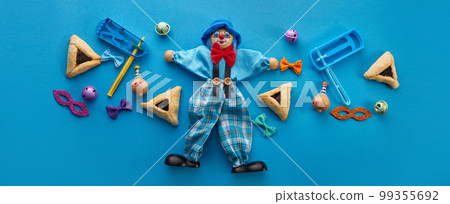 Purim celebration concept. Jewish carnival background. hamantaschen or hamans ears cookies, carnival mask and noisemaker 99355692