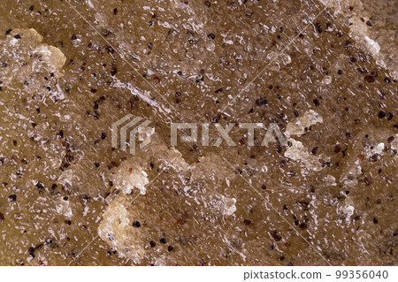 Scrub with coffee and honey texture close up. Texture of coffee and sugar scrub's smear with exfoliating particles. Concept of spa and self-care beauty treatments. Cosmetics texture as a background. Scrub with coffee and honey texture close up. Texture of coffee and sugar scrub's smear with exfoliating particles. Concept of spa and self-care beauty treatments. Cosmetics texture as a background. 99356040