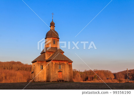 Wooden 18th century church of St. Nicholas in authentic Cossack farm in Stetsivka village in Cherkasy region, Ukraine 99356190
