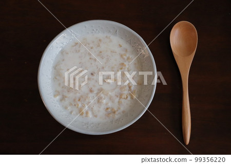 Oatmeal with milk, black background 99356220