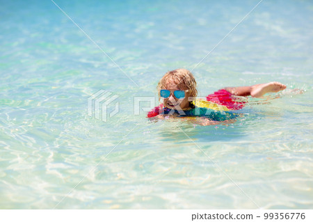 Kids surf on tropical beach. Vacation with child. Kids surf on tropical beach. Vacation with child. 99356776