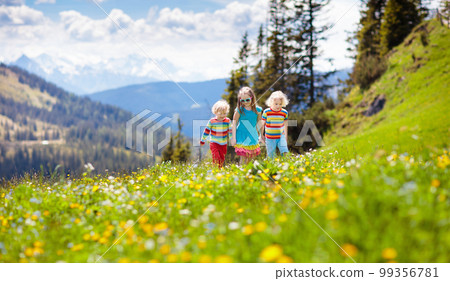 Children hiking in Alps mountains. Kids outdoor. 99356781