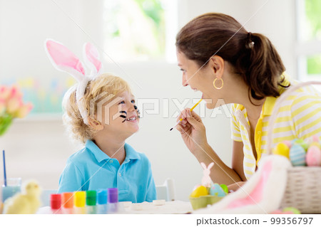 Mother and kids, family coloring Easter eggs. 99356797