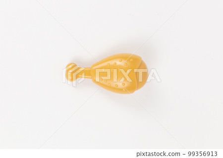 chicken leg plastic toy child on a white background 99356913