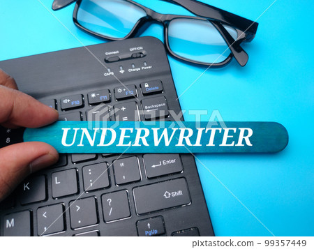 Keyboard and glasses with the word UNDERWRITER on a blue background. 99357449