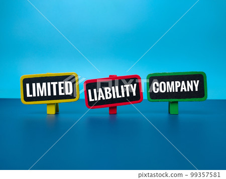 Colored wooden board with the word LIMITED LIABILITY COMPANY on blue background. Business concept. Colored wooden board with the word LIMITED LIABILITY COMPANY on blue background. Business concept. 99357581
