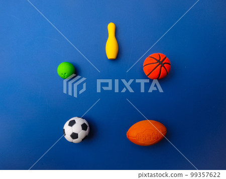 Top view of various sports balls on blue background. Top view of various sports balls on blue background. 99357622