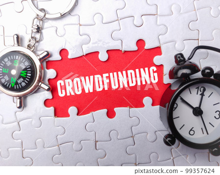 Clock and compass with the word CROWDFUNDING on a white puzzle background. Clock and compass with the word CROWDFUNDING on a white puzzle background. 99357624