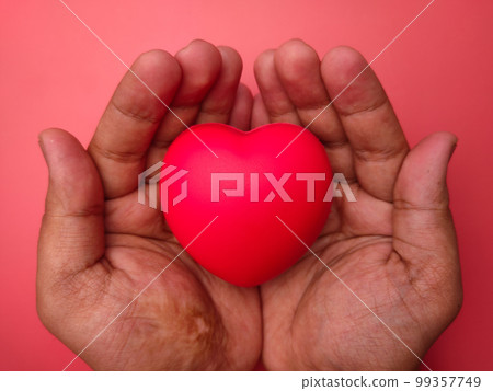 Hand holding red love heart on a red background. Healthcare and valentine concept. Hand holding red love heart on a red background. Healthcare and valentine concept. 99357749