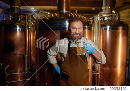 Brewery technologist tasting fresh craft beer at microbrewery plant 99358101