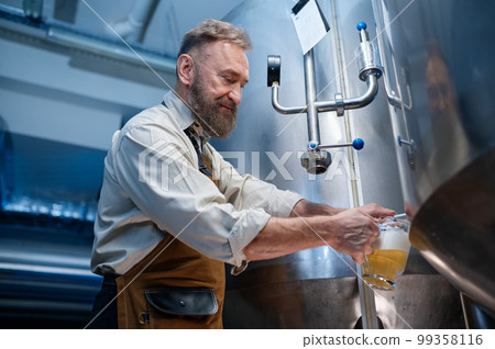 Brewery master quality tasting of craft beer at production facility 99358116