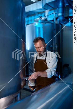 Brewery master quality tasting of craft beer at production facility 99358122