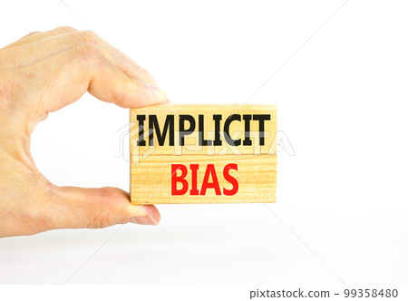 Implicit bias symbol. Concept words Implicit bias on wooden block. Beautiful white table white background. Businessman hand. Business psychology implicit bias concept. Copy space. Implicit bias symbol. Concept words Implicit bias on wooden block. Beautiful white table white background. Businessman hand. Business psychology implicit bias concept. Copy space. 99358480