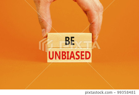 Be unbiased symbol. Concept words Be unbiased on wooden block. Beautiful orange table orange background. Businessman hand. Business psychology be unbiased concept. Copy space. 99358481
