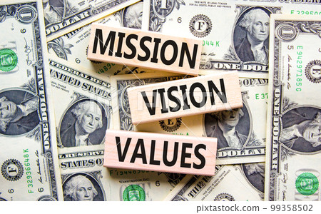 Mission vision values symbol. Concept words Mission Vision Values on wooden blocks on a beautiful background from dollar bills. Business mission vision values concept. Copy space. Mission vision values symbol. Concept words Mission Vision Values on wooden blocks on a beautiful background from dollar bills. Business mission vision values concept. Copy space. 99358502