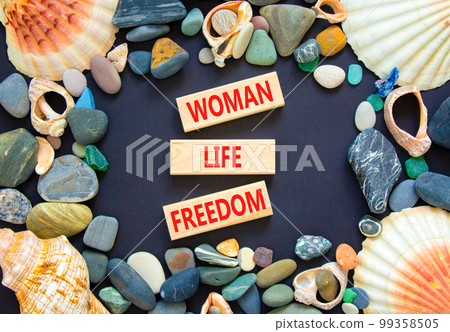 Woman life freedom symbol. Concept words Woman Life Freedom on wooden blocks on a beautiful black table black background. Sea stone, sea shell. Social issue woman life freedom concept. Copy space. Woman life freedom symbol. Concept words Woman Life Freedom on wooden blocks on a beautiful black table black background. Sea stone, sea shell. Social issue woman life freedom concept. Copy space. 99358505