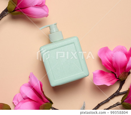 Plastic soap dispenser container on a beige background, cosmetics Plastic soap dispenser container on a beige background, cosmetics 99358804
