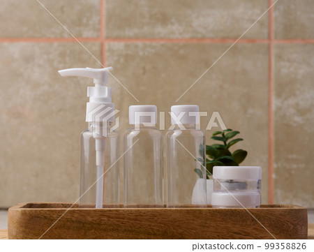 Transparent plastic container for cosmetics on the table, bottles for liquid cosmetics Transparent plastic container for cosmetics on the table, bottles for liquid cosmetics 99358826