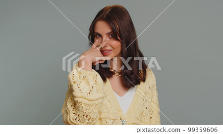 Serious woman pointing at her eyes show I am watching you gesture spying on someone guilty disbelief Serious woman pointing at her eyes show I am watching you gesture spying on someone guilty disbelief 99359606
