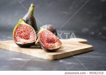 fig on a wooden board on white background,  99362319