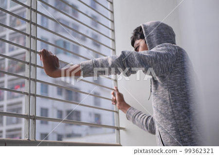 sad teenage boy looking through window sad teenage boy looking through window 99362321