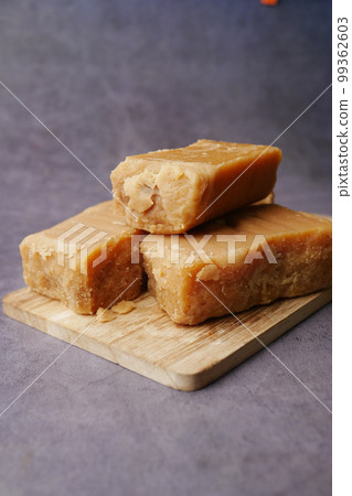 Jaggery traditional cane sugar cube on table Jaggery traditional cane sugar cube on table 99362603