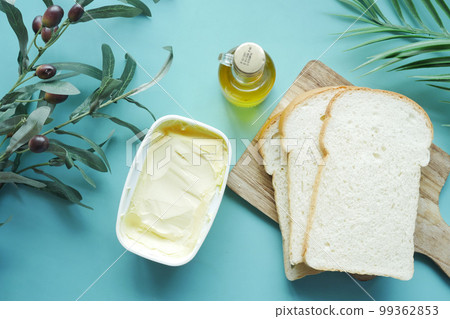 fresh olive butter in a container with bread on table fresh olive butter in a container with bread on table 99362853