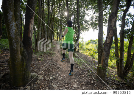 Woman trail runner running at sunrise tropical forest mountain peak Woman trail runner running at sunrise tropical forest mountain peak 99363815