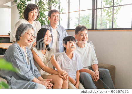 Three-generation family family gathering on the sofa at home 99367621