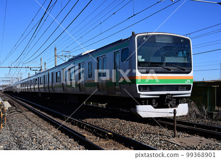 (Railway scenery) Commuter train E231 series running under the blue sky (Railway scenery) Commuter train E231 series running under the blue sky 99368901