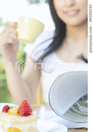 A woman reading a magazine A woman reading a magazine 99369295