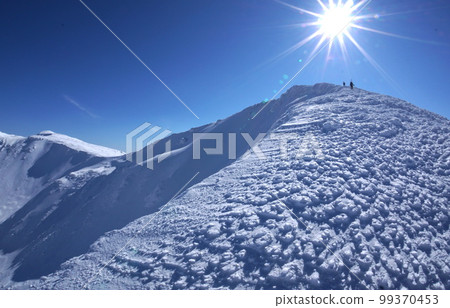 Climbers climbing the ridgeline of Mt. Minamidake, Shiretoko Peninsula in winter 99370453