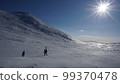 Climbers walking through the frozen Futatsuike Campsite on the Shiretoko Peninsula in winter 99370478