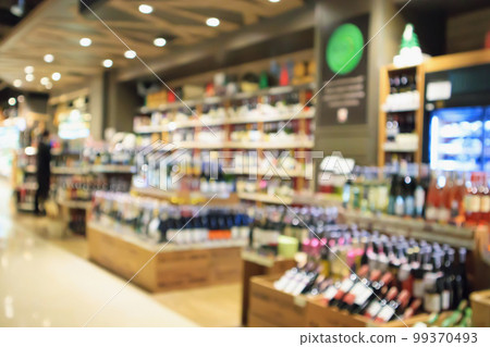Abstract blur wine bottles on liquor alcohol shelves in supermarket or wine store background Abstract blur wine bottles on liquor alcohol shelves in supermarket or wine store background 99370493
