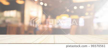 Wood table top with Restaurant cafe or coffee shop interior with people abstract defocused blur background 99370561