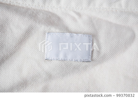 White blank laundry care clothes label on cotton shirt White blank laundry care clothes label on cotton shirt 99370832