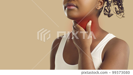 Unknown young dark skinned woman holding her throat while standing on beige background. Banner. Unknown young dark skinned woman holding her throat while standing on beige background. Banner. 99373080