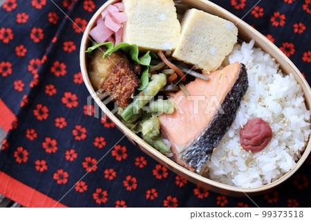 Handmade Japanese lunch box with grilled salmon in a bento box Handmade Japanese lunch box with grilled salmon in a bento box 99373518