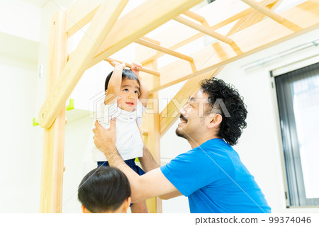 A 3-year-old boy enjoying the ladder A 3-year-old boy enjoying the ladder 99374046