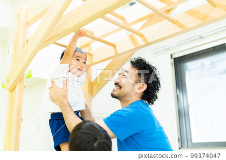 A 3-year-old boy enjoying the ladder A 3-year-old boy enjoying the ladder 99374047