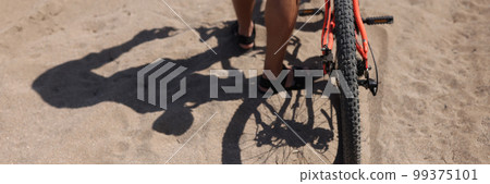 Rear wheel of mountain bike and rider leg 99375101