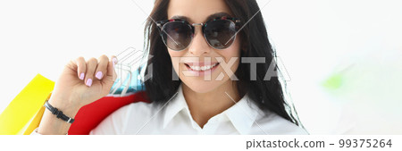 Portrait of astonished charming brunette holding shopping bags with glasses Portrait of astonished charming brunette holding shopping bags with glasses 99375264