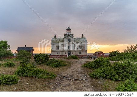 Stone lighthouse building in summer afternoon sun on Stora Karlso. Gotland, Sweden Stone lighthouse building in summer afternoon sun on Stora Karlso. Gotland, Sweden 99375554
