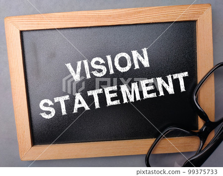 Black wooden board and glasses with the word VISION STATEMENT. Business concept. 99375733