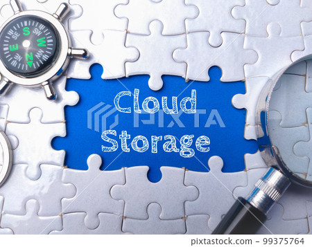 Magnifying glass and compass with the word Cloud Storage on blue background. Magnifying glass and compass with the word Cloud Storage on blue background. 99375764