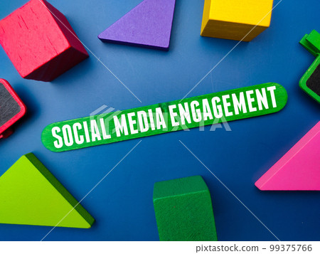 Colored wooden block and ice cream stick with the word SOCIAL MEDIA ENGAGEMENT. 99375766