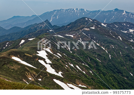 Mountain ranges with remaining snow seen from the Tanigawa mountain range and Mt. Mountain ranges with remaining snow seen from the Tanigawa mountain range and Mt. 99375773