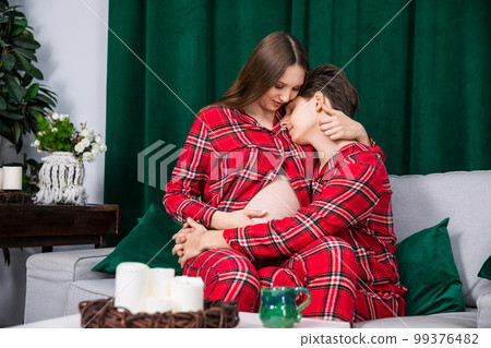 Girl sits on lap of boy who hugs her Girl sits on lap of boy who hugs her 99376482