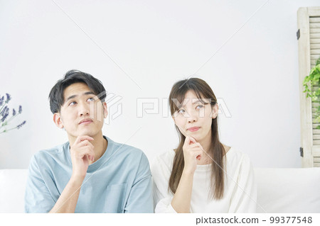 couple thinking at home 99377548